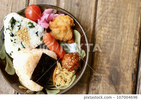 Salmon and wakame rice balls on a plate Salmon and wakame rice balls on a plate 107004696