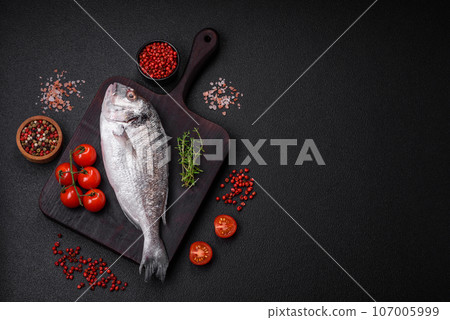 Fresh raw dorada fish with salt, spices and herbs 107005999