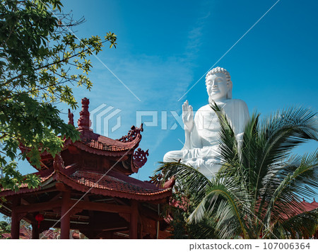 Buddha statue surrounded at Chua Hue Chieu temple in Kontum, Vietnam 107006364