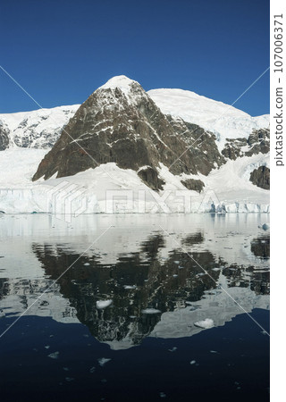 Glaciers and mountains in Paradise bay, peninsula, Antartica.. Glaciers and mountains in Paradise bay, peninsula, Antartica.. 107006371