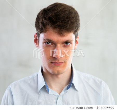 Portrait of young serious guy in studio Portrait of young serious guy in studio 107006699