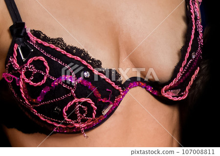 Female body erotic concept in bra with vintage patterns, close up Female body erotic concept in bra with vintage patterns, close up 107008811