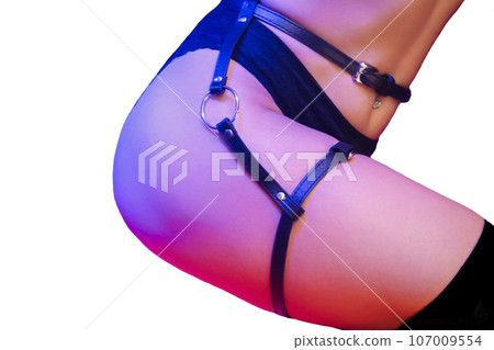 Women's light erotica, black belt for the body and legs of a sexy dancer in neon light, nightlife on white background isolated 107009554