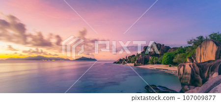 Beautifully shaped granite boulders and a dramatic sunset at picture perfect tropical Anse Source d'Argent beach, La Digue island, Seychelles. Beautifully shaped granite boulders and a dramatic sunset at picture perfect tropical Anse Source d'Argent beach, La Digue island, Seychelles. 107009877