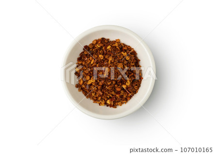 Cayenne pepper powder in white bowl isolated on white background with clipping path.Top view 107010165