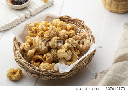 Pork crackling,deep fried pork skin on wicker basket,yummy snacks food. 107010173