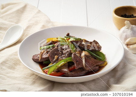 Stir Fried Pork Liver and Sweet Pepper with Black Peppercorn in white plate Stir Fried Pork Liver and Sweet Pepper with Black Peppercorn in white plate 107010194