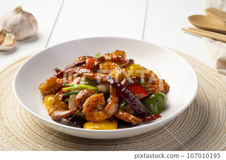 Stir fried crispy shrimp with cashew nuts and sweet pepper in white plate.Thai food not spicy. Stir fried crispy shrimp with cashew nuts and sweet pepper in white plate.Thai food not spicy. 107010195
