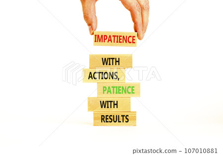 Action and result symbol. Concept words Impatience with actions patience with results on wooden block. Beautiful white table white background. Businessman hand. Business action result concept. Action and result symbol. Concept words Impatience with actions patience with results on wooden block. Beautiful white table white background. Businessman hand. Business action result concept. 107010881