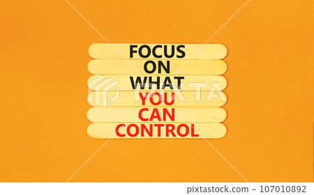Focus on control symbol. Concept words Focus on what you can control on wooden stick. Beautiful orange table orange background. Business control motivational never stress concept. 107010892