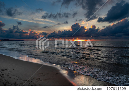 sunset on a sandy beach with dramatic cloudy sky in Golem, Durres, Albania 107011809