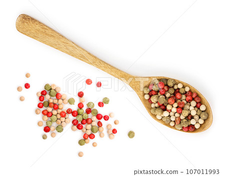 mix of peppercorn in wooden spoon isolated on white background. Top view. Flat lay mix of peppercorn in wooden spoon isolated on white background. Top view. Flat lay 107011993