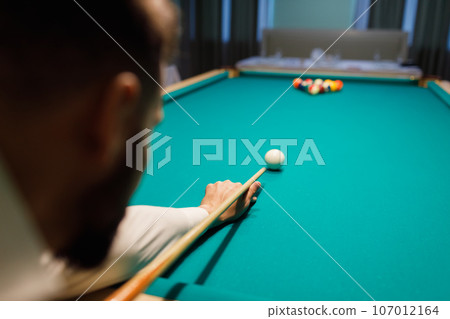 Billiard player at billard table or snooker american billiards pool sport game 107012164