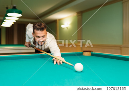 Billiard player aiming at billard table or snooker american billiards pool sport game 107012165
