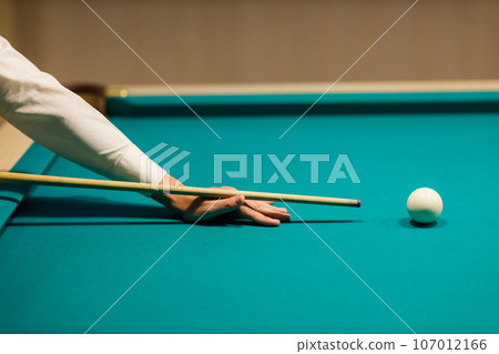 Billiard coach trainer instructor teaches player at billard table or snooker american billiards pool sport game 107012166