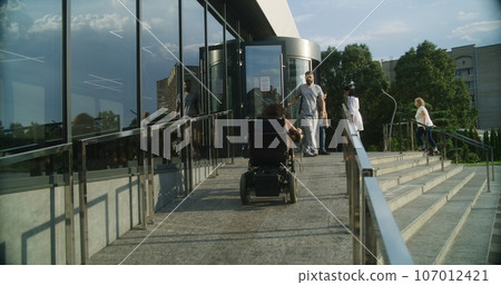 Male nurse meets female patient with disability 107012421