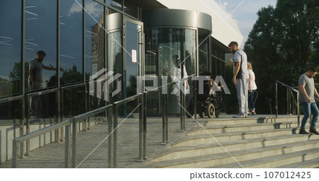Male nurse meets female patient with disability 107012425