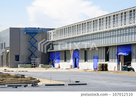 Unfinished modern commercial building facade fragment, self propelled scissor lift Unfinished modern commercial building facade fragment, self propelled scissor lift 107012510