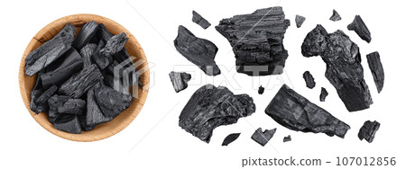 Natural charcoal in wooden bowl isolated on white background with full depth of field. Top view. Flat lay Natural charcoal in wooden bowl isolated on white background with full depth of field. Top view. Flat lay 107012856