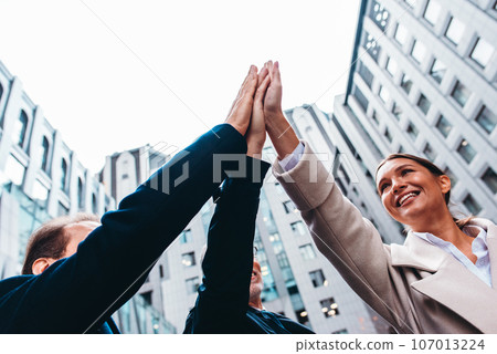 Business people putting their hands together as teamwork and partner 107013224