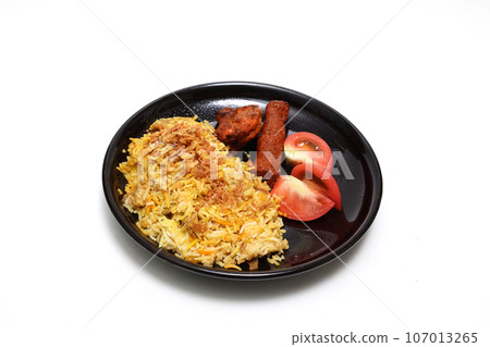 Biryani on a black plate with white background Biryani on a black plate with white background 107013265