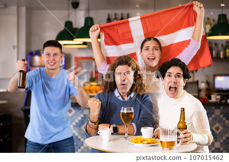 Joyful fans of the Denmark team celebrating the victory in night bar Joyful fans of the Denmark team celebrating the victory in night bar 107015462