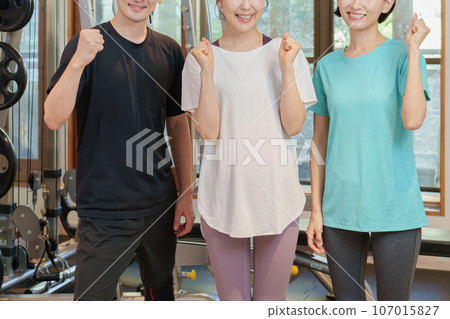 Instructor doing fist pump at personal gym Instructor doing fist pump at personal gym 107015827