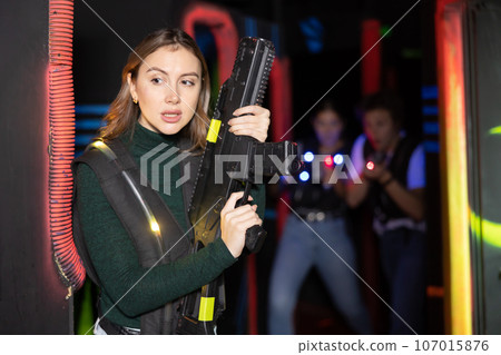 Young woman playing lasertag in arena 107015876
