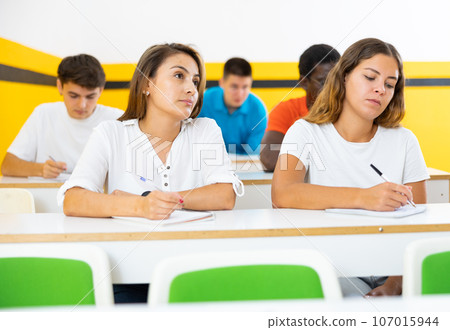 Woman and girl listening lecture in taxi driving school Woman and girl listening lecture in taxi driving school 107015944