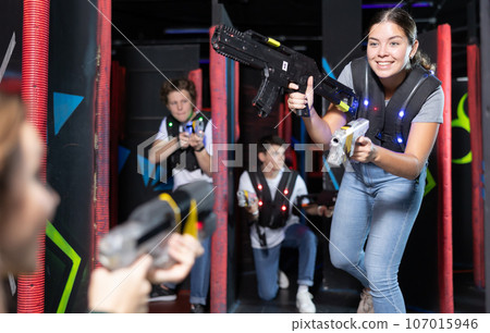 Young woman playing lasertag in arena 107015946