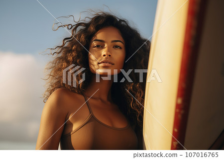 Female Hispanic surfer with surf board, lifestyle closeup portrait Female Hispanic surfer with surf board, lifestyle closeup portrait 107016765