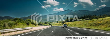 Compact Crossover SUV In Motion On Road, Freeway, Motorway, Highway In Mountains Landscape. Drive Travel Concept 107017365