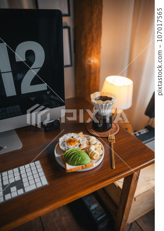 Coffee and breakfast on the desk Coffee and breakfast on the desk 107017565