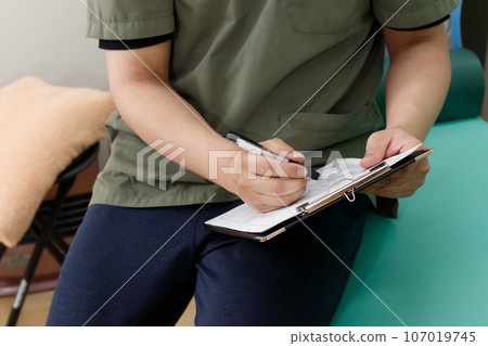 A man fills out a medical questionnaire. Listen to treatment policies and patient concerns 107019745