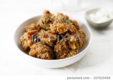 Fried chicken with soy sauce in Korean style with pickled radish. Fried chicken with soy sauce in Korean style with pickled radish. 107020489