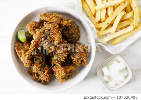 Fried chicken with soy sauce in Korean style with pickled radish. 107020493