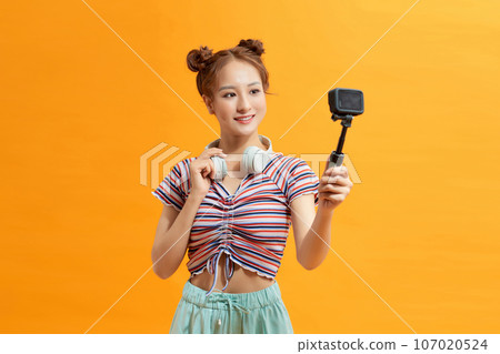 Girl recording vacation with action camera. Girl recording vacation with action camera. 107020524