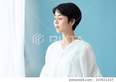 A woman thinking on the window side A woman thinking on the window side 107021107