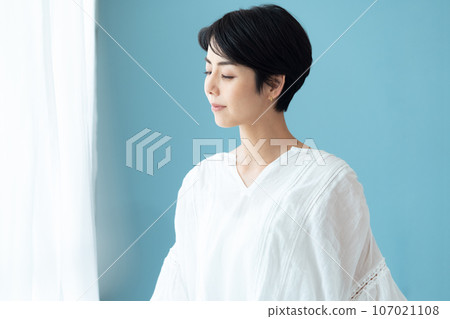 A woman thinking on the window side 107021108