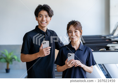 gym instructor with smartphone gym instructor with smartphone 107021450