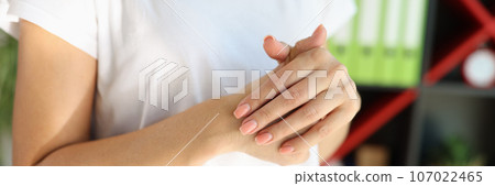Woman massaging her painful hands in office close up. 107022465