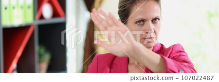 Business woman refuses offers while sitting at office table. Business woman refuses offers while sitting at office table. 107022487