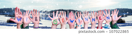 Children Hands Building Word Wir Gewinnen Means Winning, Winter Background. Children Hands Building Word Wir Gewinnen Means Winning, Winter Background. 107022865