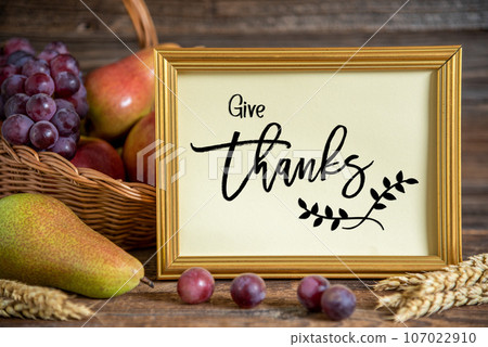 Fall Decoration with Fruits and Text Give Thanks 107022910