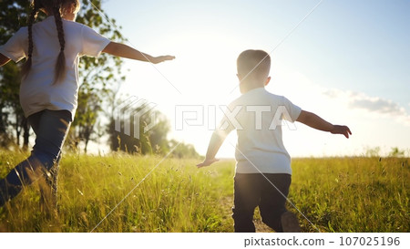 happy family kids. people in the park children child running together in the park at sunset silhouette. mom dad daughter and son are run happy family and little child in summer. dream fun kids run happy family kids. people in the park children child running together in the park at sunset silhouette. mom dad daughter and son are run happy family and little child in summer. dream fun kids run 107025196