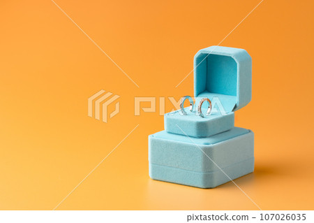 Blue jewelry box on yellow background close up 107026035