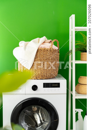 Laundry basket on washing machine in a laundry room Laundry basket on washing machine in a laundry room 107026096