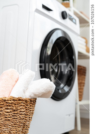 Modern white washing machine in a laundry room 107026156
