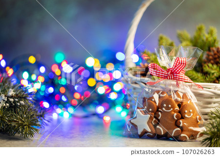 Christmas gingerbread cookies and garland lights 107026263