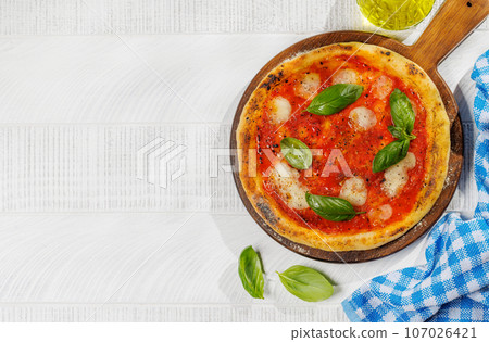 Margarita pizza with tomatoes, mozzarella cheese and basil 107026421